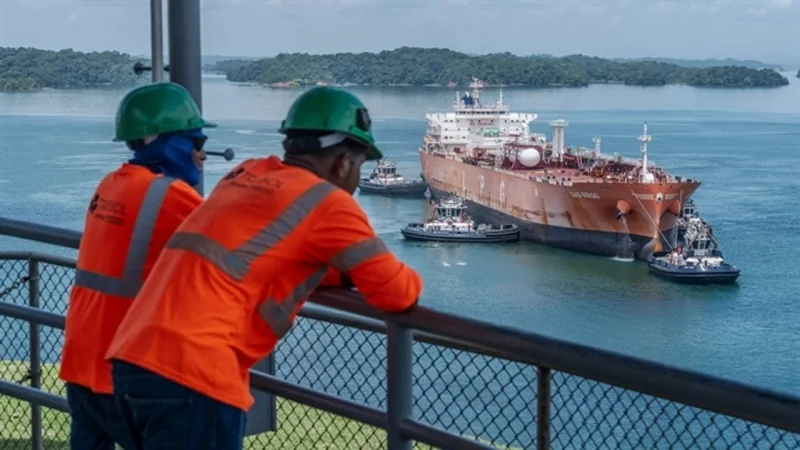 Panama Canal workers watching a tanker transit the canal