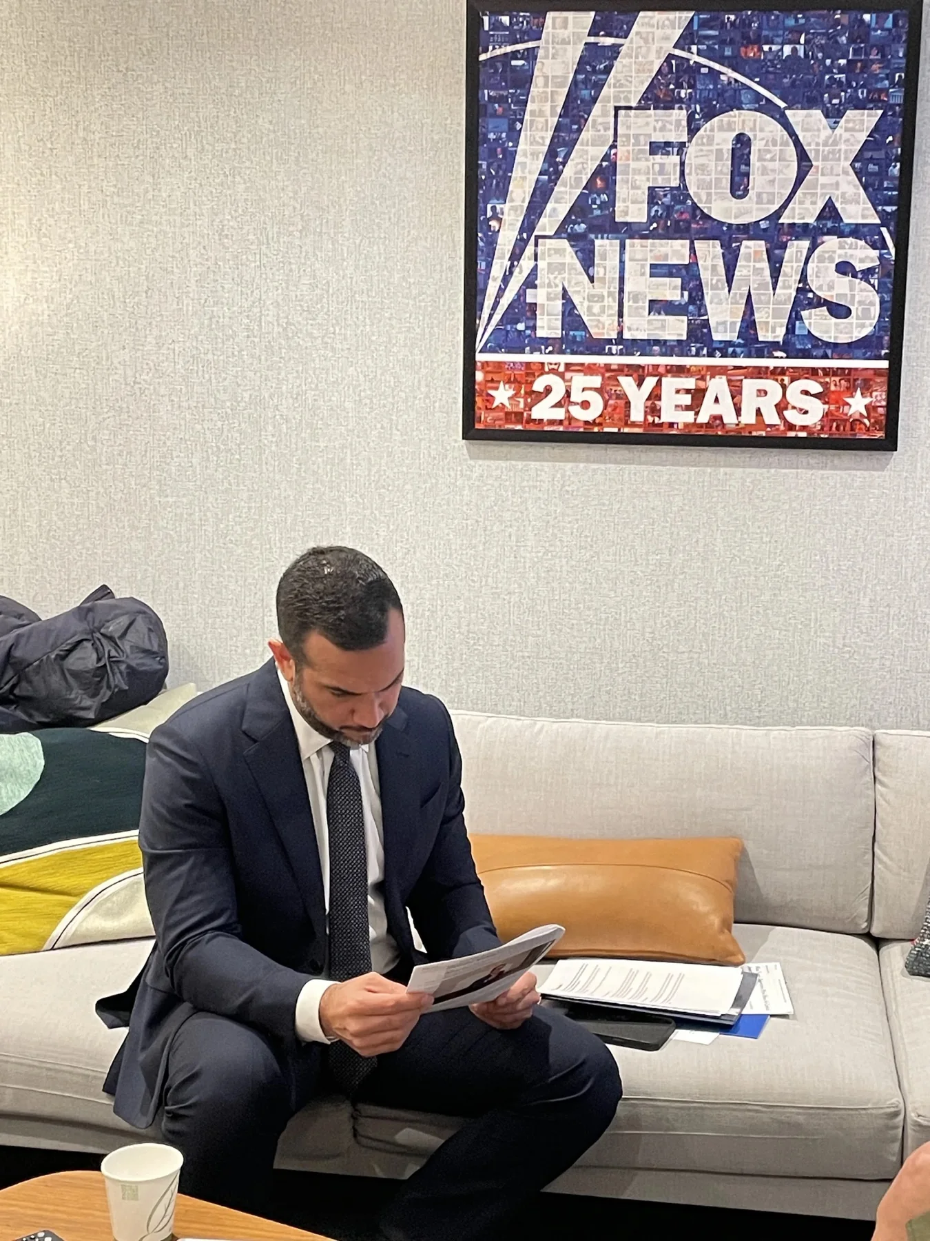 Carlos Ruiz Hernandez reviewing notes at Fox News.